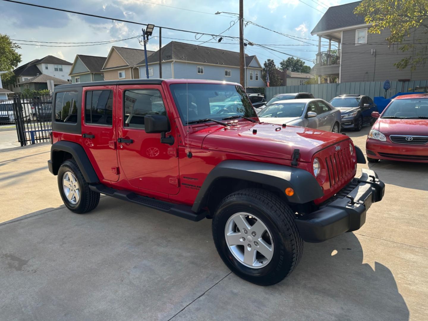 2014 Red /Black Jeep Wrangler Unlimited Sport 4WD (1C4HJWDG7EL) with an 3.6L V6 DOHC 24V FFV engine, Automatic transmission, located at 1501 West 15th St., Houston, 77008, (713) 869-2925, 29.797941, -95.411789 - Photo#1