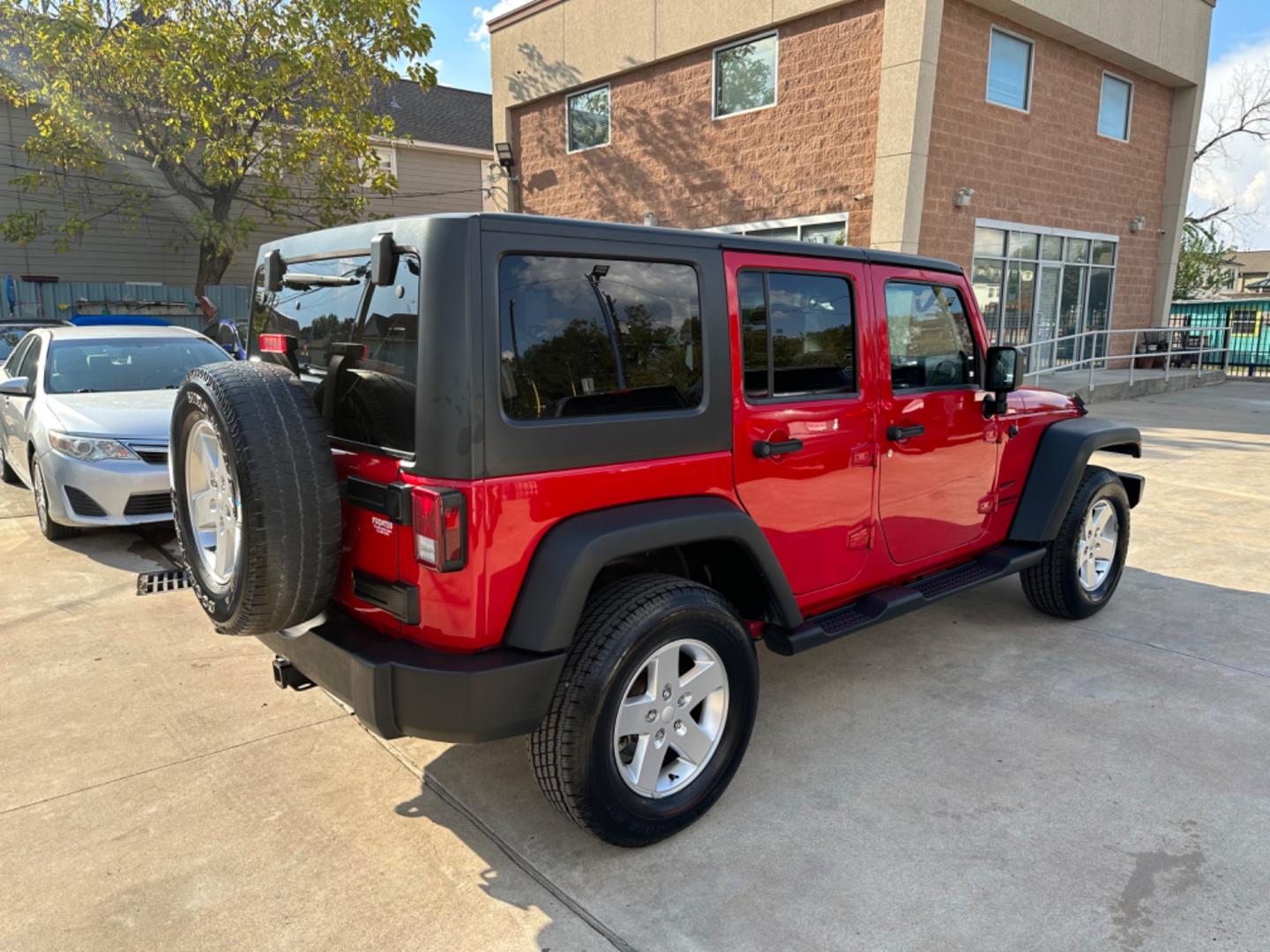 2014 Red /Black Jeep Wrangler Unlimited Sport 4WD (1C4HJWDG7EL) with an 3.6L V6 DOHC 24V FFV engine, Automatic transmission, located at 1501 West 15th St., Houston, 77008, (713) 869-2925, 29.797941, -95.411789 - Photo#2