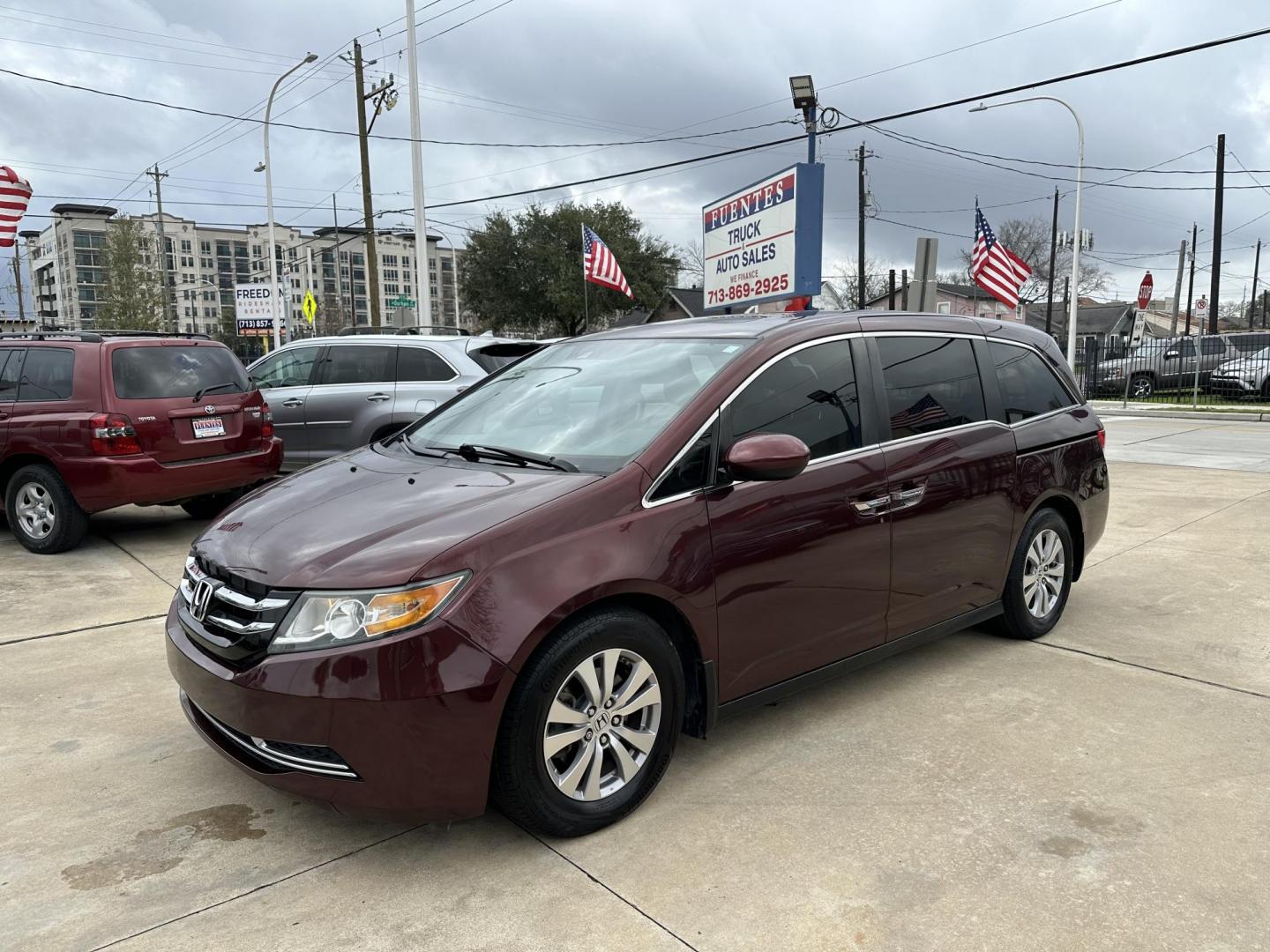 2017 Maroon /Silver Honda Odyssey EX-L w/Navigation (5FNRL5H68HB) with an 3.5L V6 SOHC 24V engine, 6A transmission, located at 1501 West 15th St., Houston, 77008, (713) 869-2925, 29.797941, -95.411789 - Photo#0