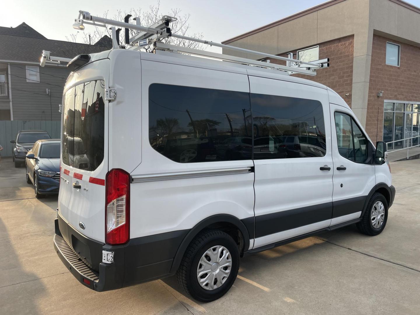 2018 White /Black Ford Transit 150 Wagon Med. Roof XLT w/Sliding Pass. 130-in. WB (1FDZK1CM5JK) with an 3.7L V6 DOHC 24V engine, 6A transmission, located at 1501 West 15th St., Houston, 77008, (713) 869-2925, 29.797941, -95.411789 - Photo#2